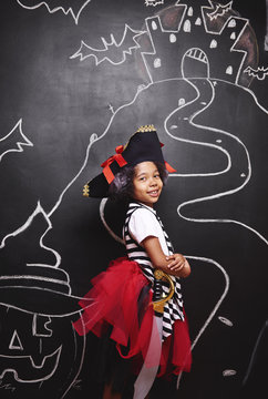 Mixed race girl in pirate costume