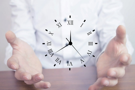 Businessman holding clock. Business time management .