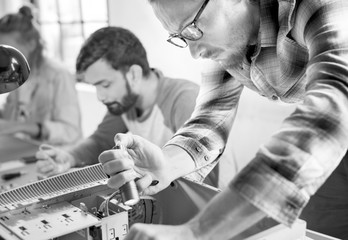 Technicians working on computer electronics parts