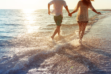 Happy young couple enjoying the sea