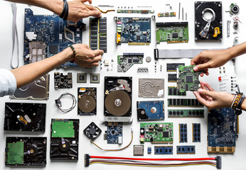 Aerial view of hands with computer electronics parts on white background - obrazy, fototapety, plakaty