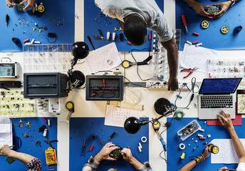 Aerial view of electronics technicians team working - obrazy, fototapety, plakaty