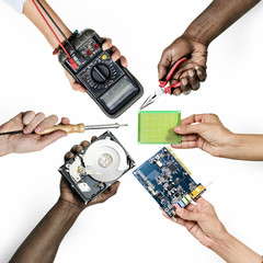 Group of hands holding computer electronics parts isolated on white