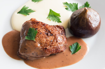 fried in herbs chicken tight stewed in red wine with figs garnished with potato puree and decorated with parsley