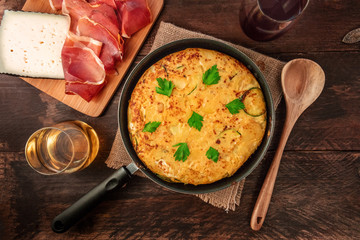 Spanish tortilla in tortillera, with wine, jamon, and cheese