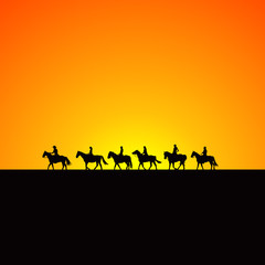 Fototapeta na wymiar Horse riders silhouettes at sunrise