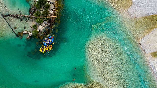 Whitewater Rafting on the Emerald waters of Soca river, Slovenia, are the rafting paradise for adrenaline seekers and also nature lovers, aerial view.