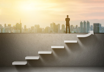 Businessman stand on rising arrow graph on staircase with city sunrise background - obrazy, fototapety, plakaty