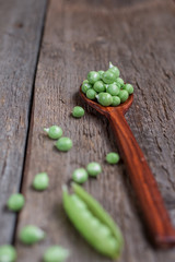 fresh peas on a wooden background.