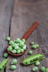 fresh peas on a wooden background