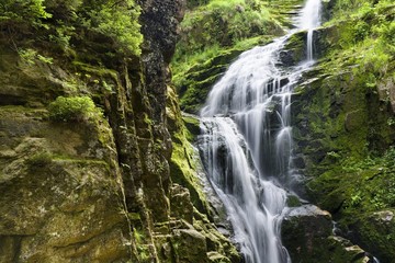 Naklejka na ściany i meble Long time exposure of Kamienczyk waterfall in Karkonosze Mountains, Poland