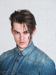 Obraz premium Man posing in blue jean shirt on white background