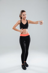 Fototapeta na wymiar Full length picture of happy fitness woman showing thumb up