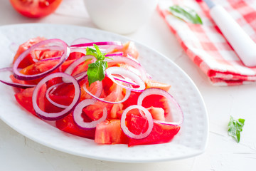 Vegetable salad of tomatoes, spring onions and sour cream