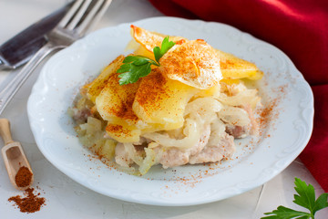 Baked potato with pork, onion, sprinkled with paprika, horizontal