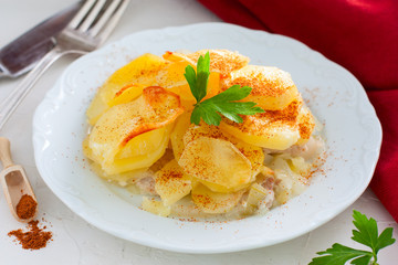 Baked potato with pork, onion, sprinkled with paprika, horizontal