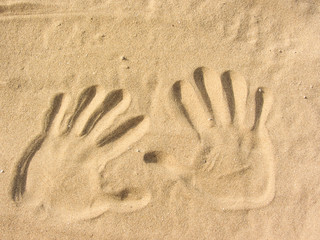 playing with sand on the beach ( two hands shape )