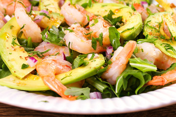Shrimp salad with avocado and arugula