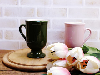coffee cup and plant on wooden table close up