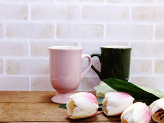 coffee cup and plant on wooden table close up