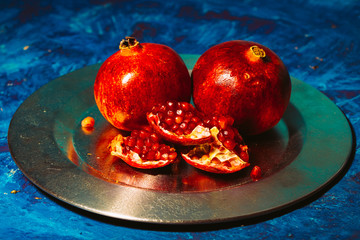Red pomegranate on metal a plate