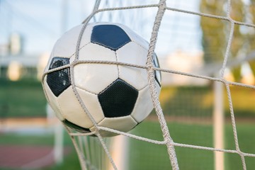 Goal - soccer or football ball in the net in stadium.