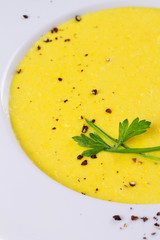 Cream corn soup in bowl on wooden background