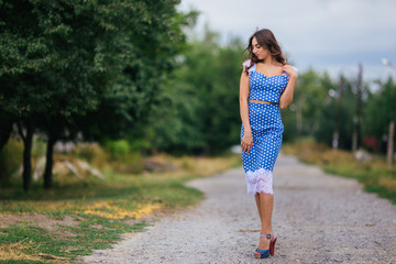 Fashion woman portrait of young pretty trendy girl with beautiful curly hair in retro style dress...