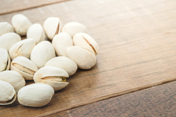 pistachio nuts on wooden table rustic surface