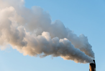 Plumes of smoke pouring out of industrial stack