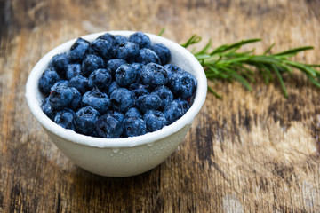 Fresh ripe blueberries in a white bowl. A useful snack