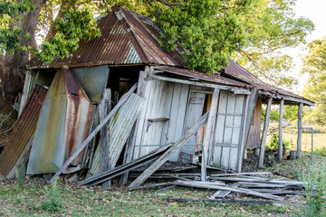 Old timber house abandoned and falling down on rural property