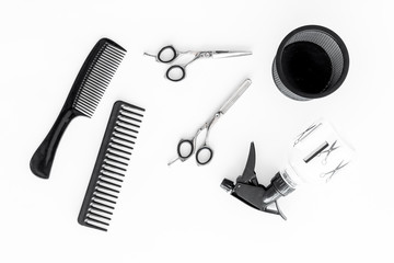 hairdresser working desk with tools for hair styling on white desk background top view