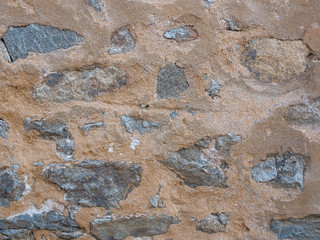 Natural stonewall texture for background. Stone wall built from stones and rocks of different sizes.