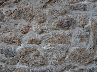 Natural stonewall texture for background. Stone wall built from stones and rocks of different sizes.