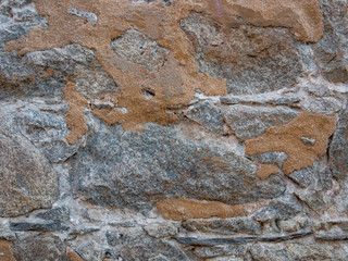Natural stonewall texture for background. Stone wall built from stones and rocks of different sizes.