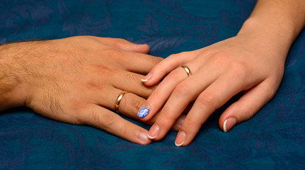 Obraz na płótnie Canvas Photo of hands with beautiful wedding rings on blue background