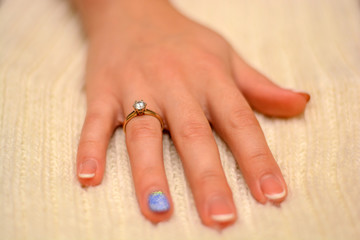 Photo of hand with wedding ring with diamond on white background