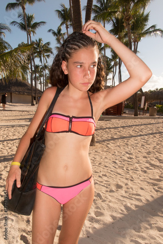 "Pretty young female model in bikini at the beach. Her ...