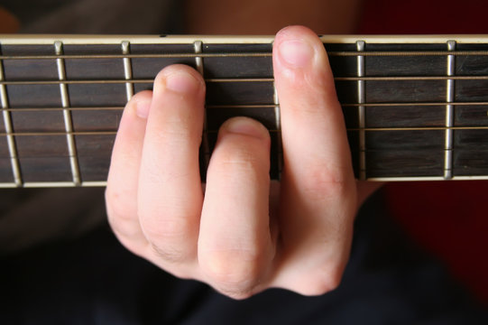 man plays the classical six-string guitar
