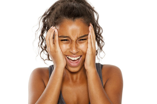 frustrated dark skinned girl screaming on white background