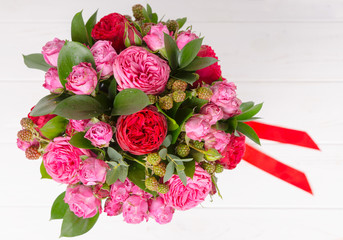 View from above of a beautiful bouquet of pink and red roses isolated on white background