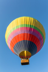 Naklejka premium Hot air baloon in blue sky close-up