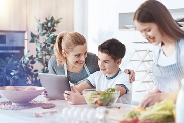 Happy family gathering together in kitchen