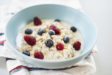 Healthy breakfast - oatmeal with blueberries and raspberries