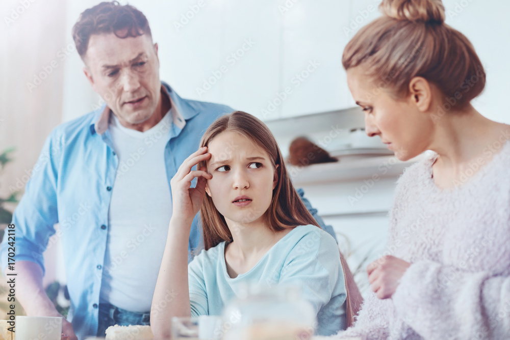 Wall mural scared parents discussing misbehavior of their daughter