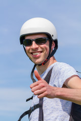 Man as paraglider wearing sunglasses and helmet