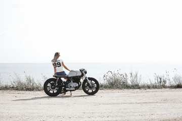 Fototapeta na wymiar Woman and motorcycle on road