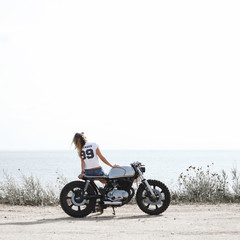 Woman and motorcycle on road