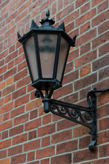 Antique lantern on a brick wall